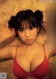 A woman in a red bra is posing for a magazine cover.