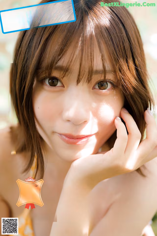A woman with brown hair is posing for a magazine cover.