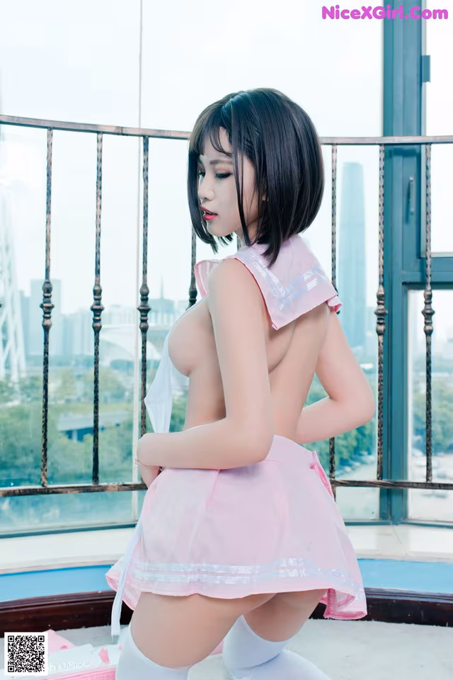 A woman in a pink dress and white stockings posing for a picture.